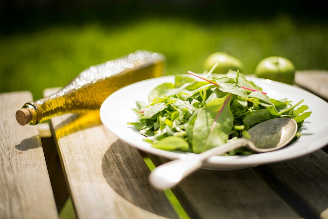 Summer grilling and fresh salad on a garden table